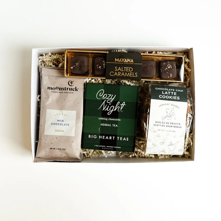 Sweets & Treats Cozy Classics Bento Box with cocoa, cookies, tea, and caramels tied with a gold bow.