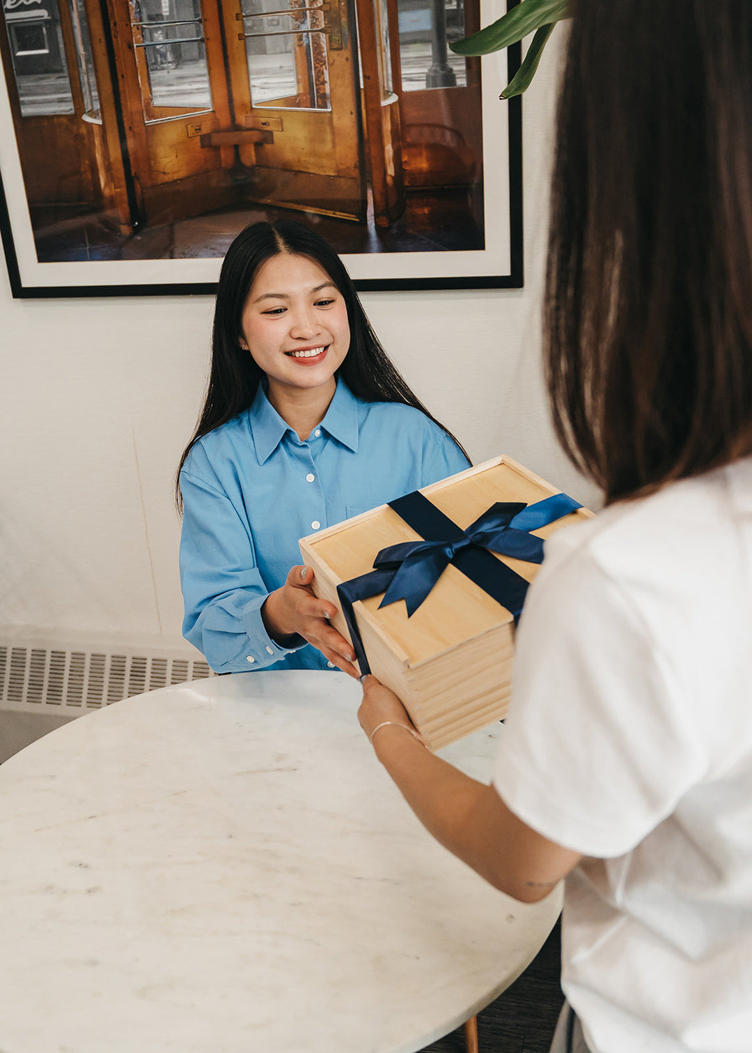 Smiling recipient accepting a Giften Market gift crate