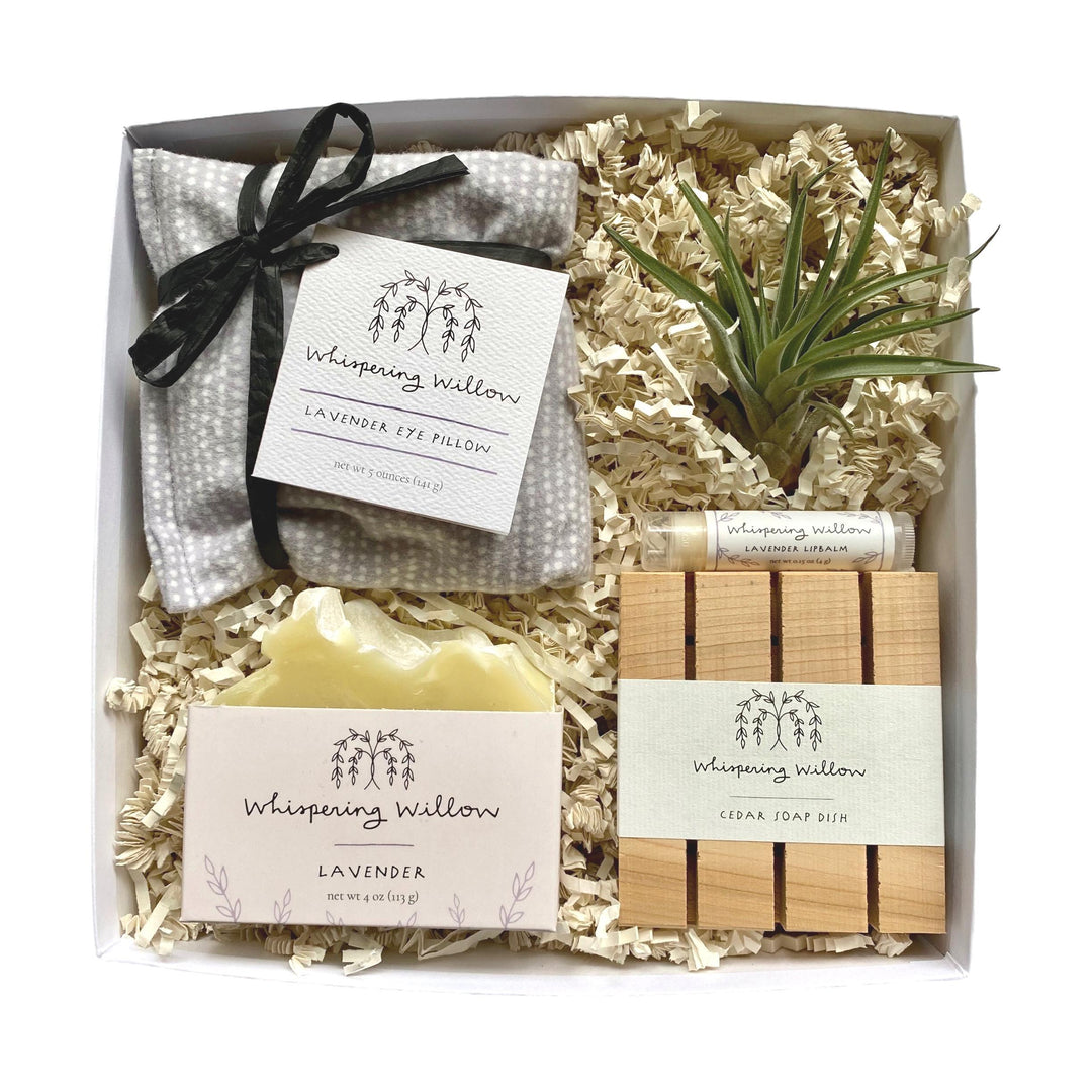 White gift box with lavender eye pillow, soap, cedar soap dish, lip balm, and air plant