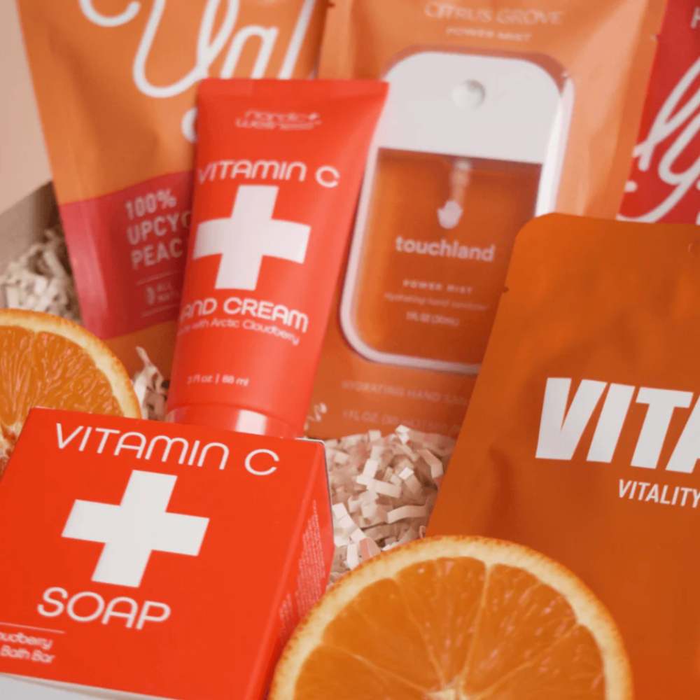 Premium care package with vitamin C soap, hand cream, snacks, and orange slices in gift box
