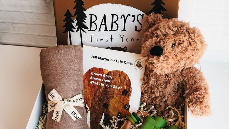 New parent gift box with plush teddy bear, baby blanket, board book, and keepsake journal