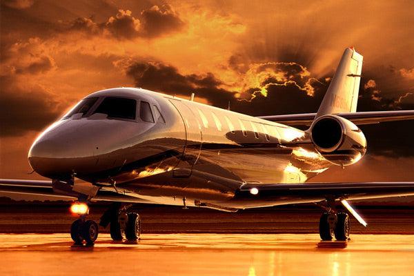 Private jet on runway at sunset with dramatic sky in the background
