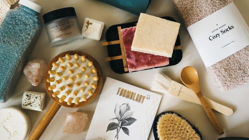 Gift box with bath salts, spa brush, cozy socks, artisan soap, candle, and skincare items