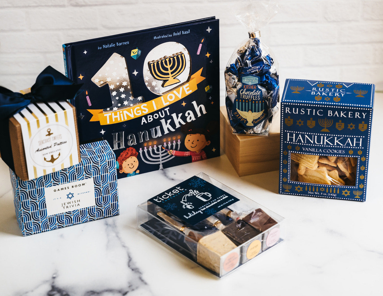 Hanukkah gift box with cookies, chocolate truffles, book, trivia game, and snack assortment