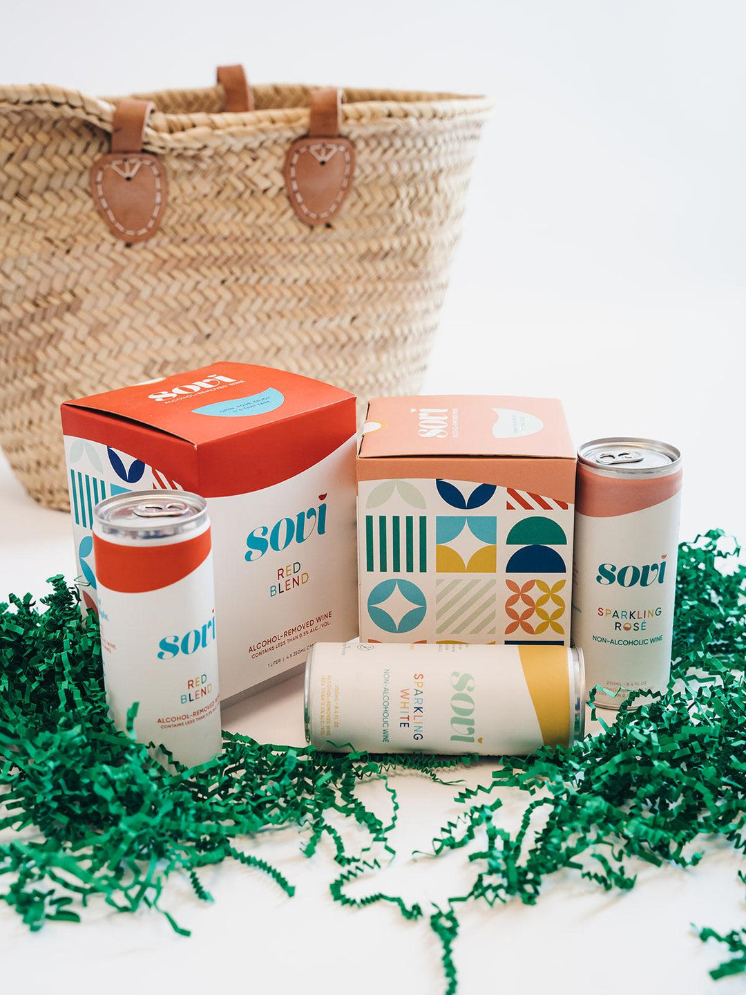 Non-alcoholic gift box with Sovi canned wine, colorful packaging, and woven gift basket