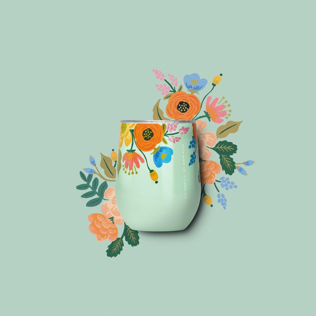 Mint green floral tumbler with colorful flowers, set against a matching floral backdrop.