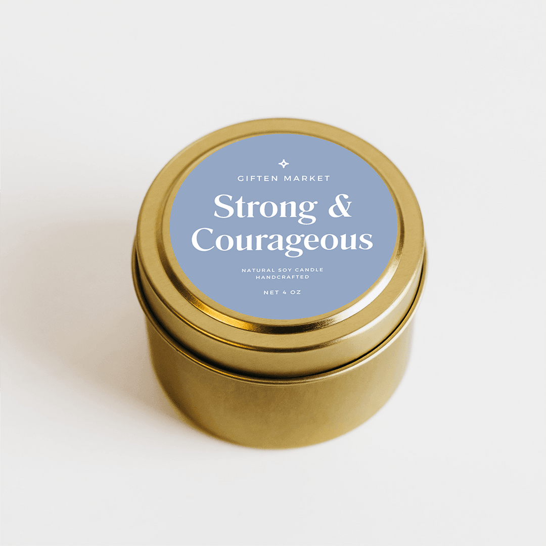 Gold travel tin soy candle with blue label on a white background