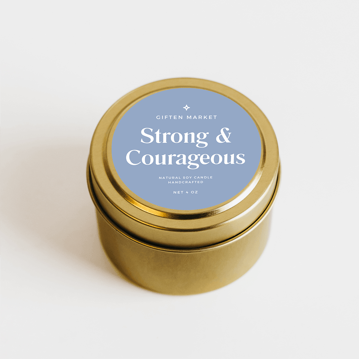 Gold travel tin soy candle with blue label on a white background