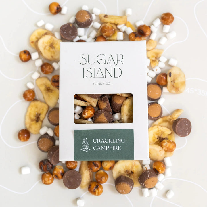 Crackling Campfire box surrounded by banana chips, marshmallows, chocolate buckeyes and pretzel balls