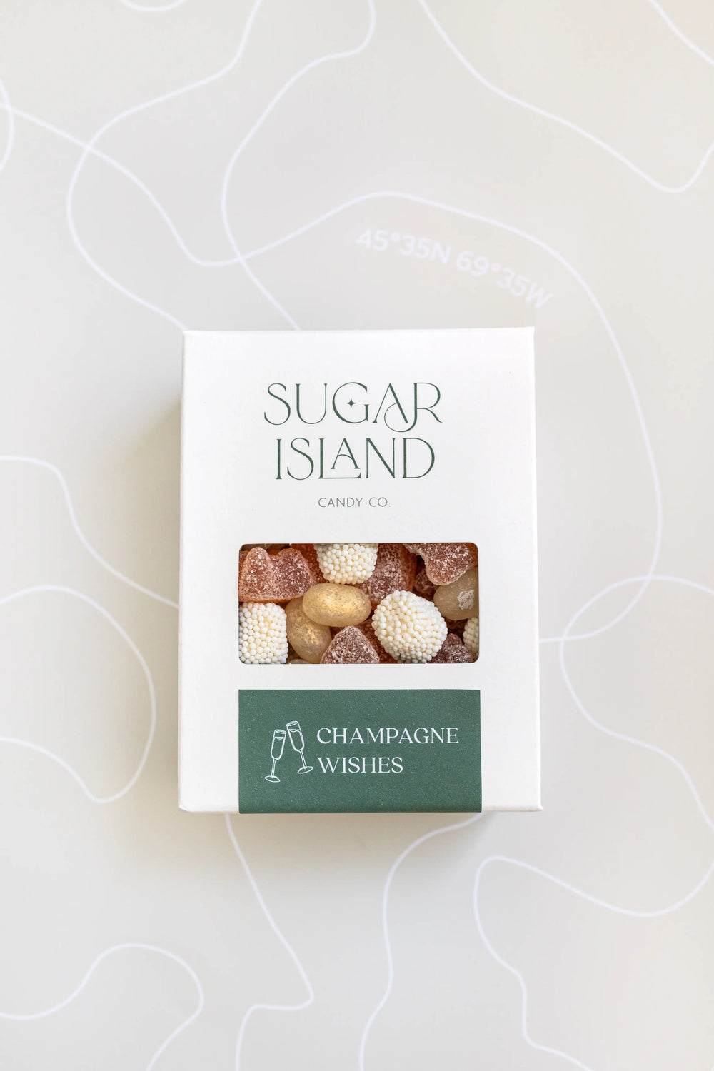 Champagne Wishes Candy Mix in a white Sugar Island box with a green label and a window showing pale pink and white candy
