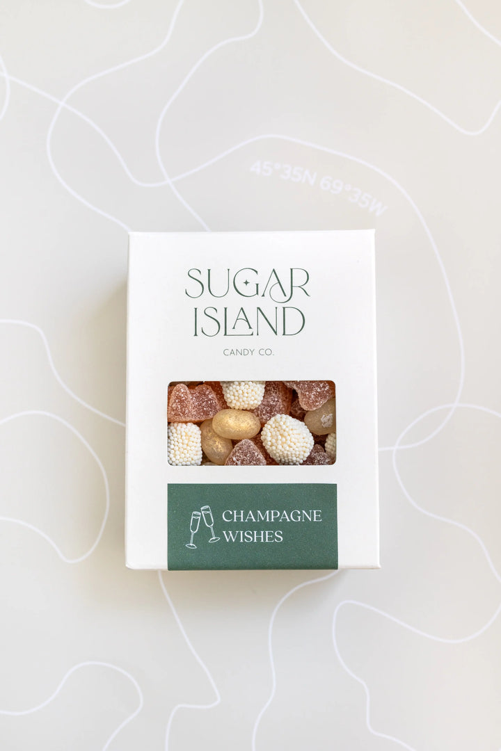 Champagne Wishes Candy Mix in a white Sugar Island box with a green label and a window showing pale pink and white candy