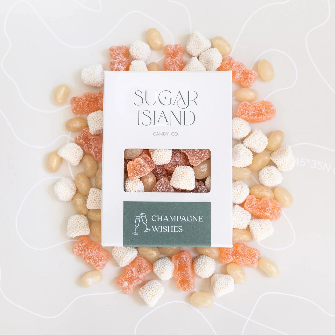 Champagne Wishes box surrounded by pink gummy bears, white candy bubbles and jelly beans