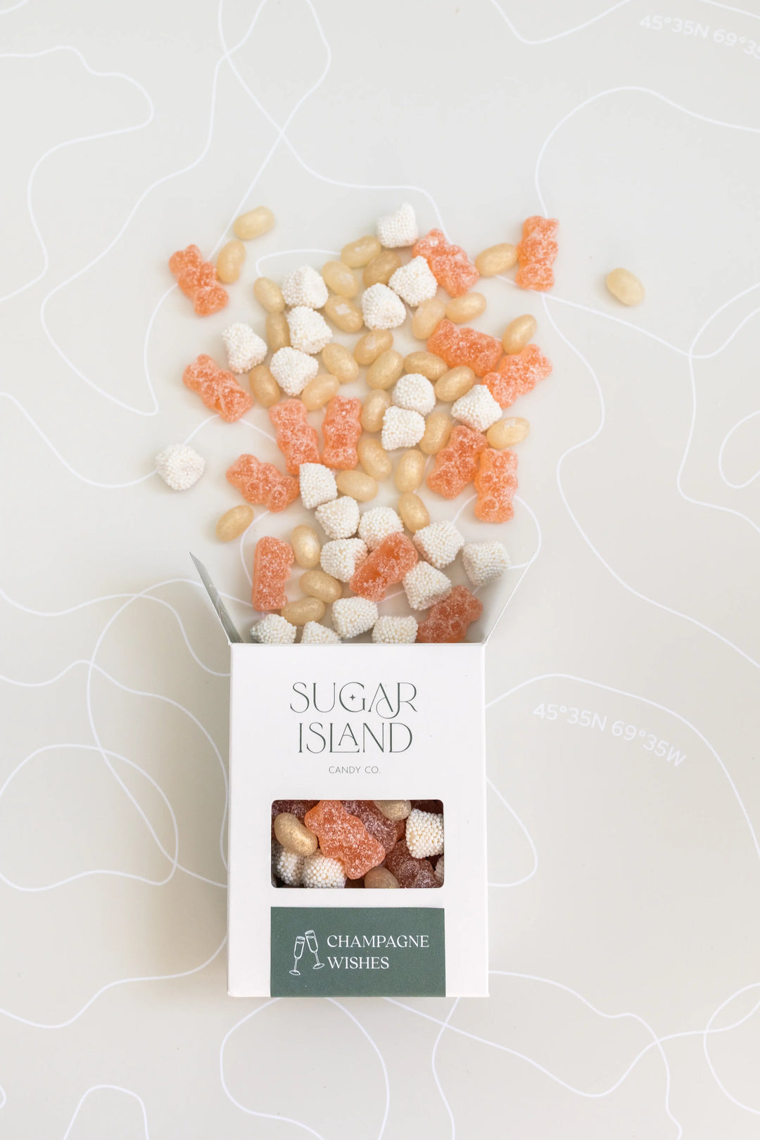 Open Champagne Wishes box with pink and white candies spilling out the top