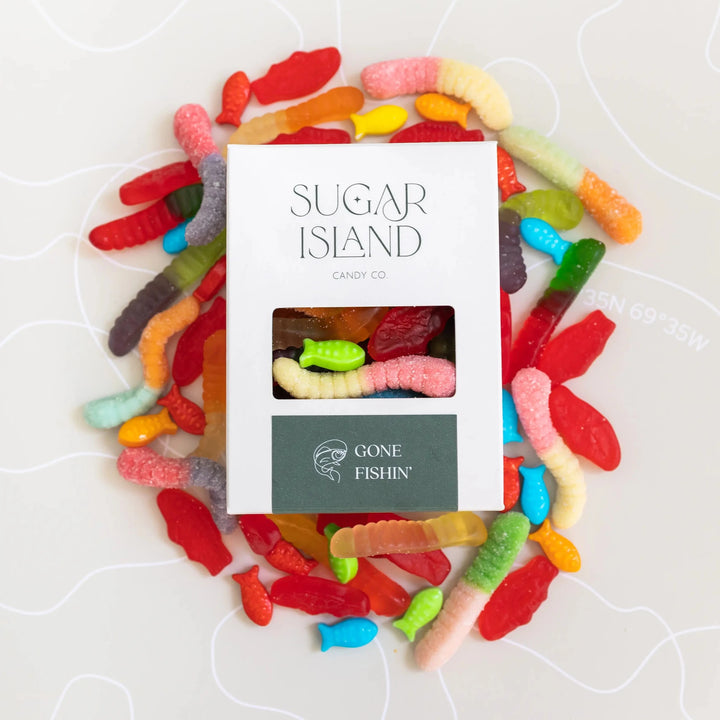 Gone Fishin box surrounded by colorful gummy worms and red candy fish