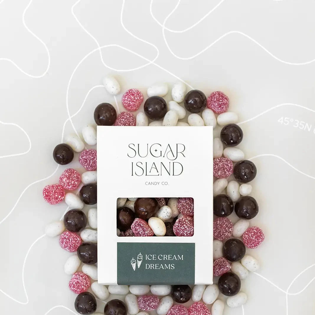 Ice Cream Dreams box surrounded by chocolate caramels, white jelly beans and pink cherry dots