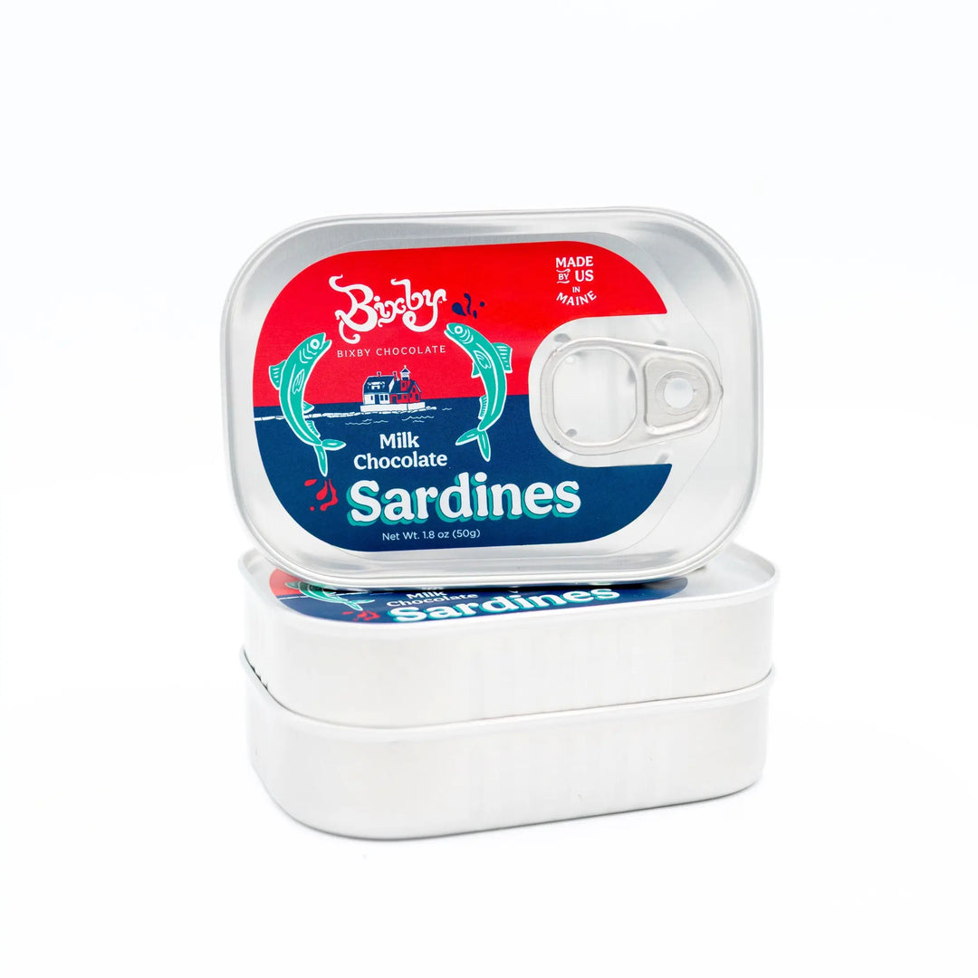Two stacked Bixby Milk Chocolate Sardines tins, the top tin showing its red, white and blue label