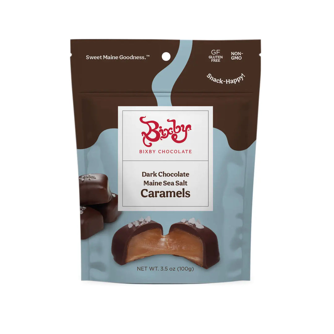 Bixby Dark Chocolate Maine Sea Salt Caramels in a brown and blue stand-up bag with a caramel shown cut open