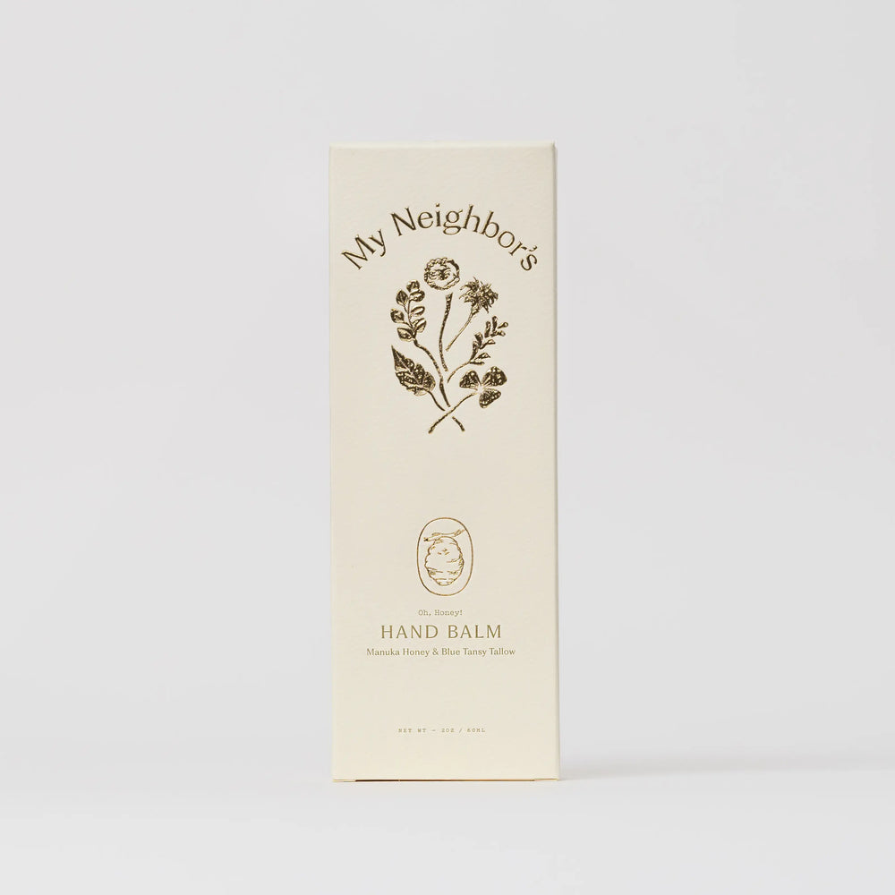 Cream My Neighbor's hand balm carton with a floral illustration