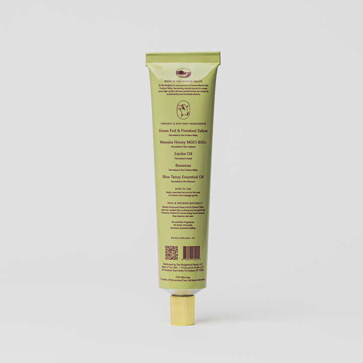 Back of the sage green hand balm tube showing the ingredient panel