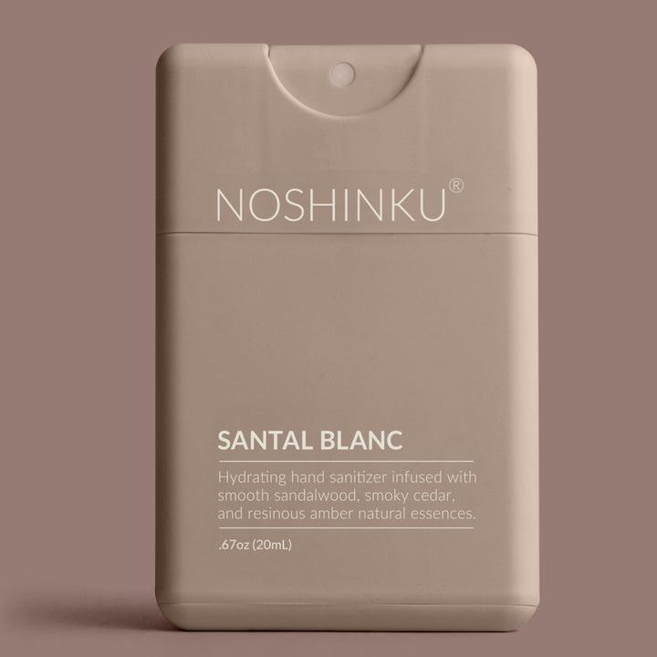 Taupe Noshinku Santal Blanc pocket hand sanitizer on a mauve background