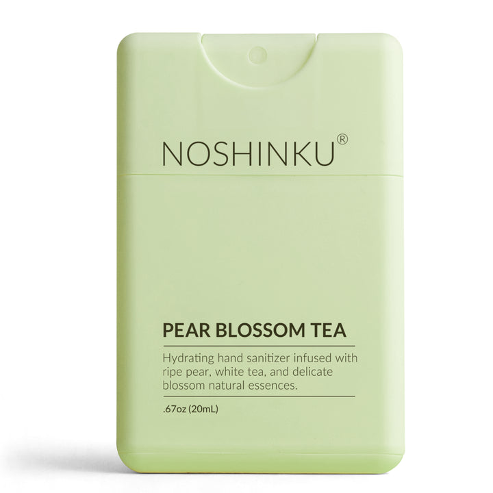Pale green Noshinku Pear Blossom Tea pocket sanitizer standing on a white background