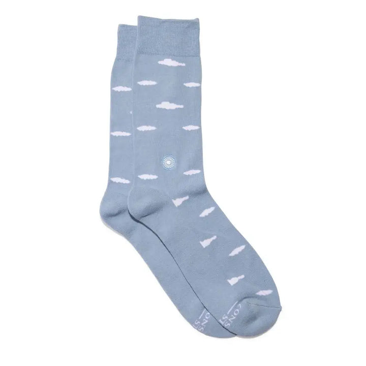 Pair of light blue crew socks with small white clouds