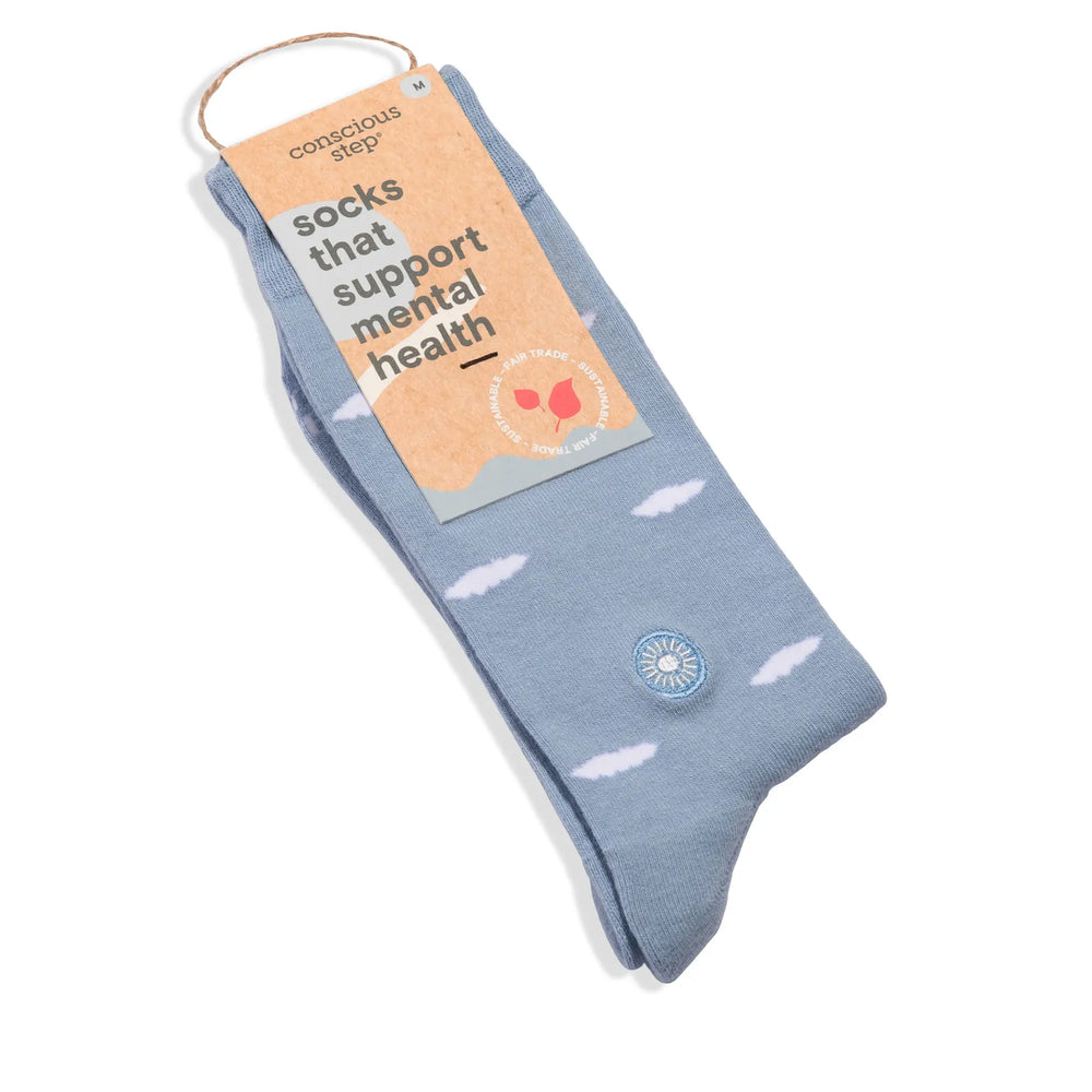 Light blue cloud socks with their Socks That Support Mental Health tag attached