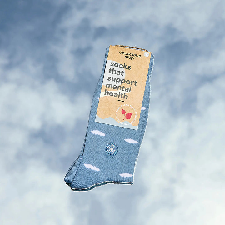 Tagged pair of blue cloud socks against a blue sky