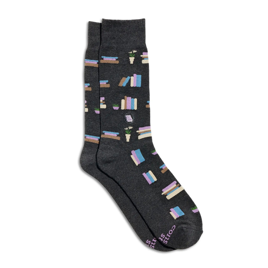 Pair of charcoal crew socks patterned with colorful stacks of books