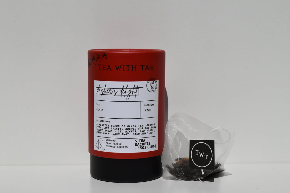 Red mini tea tube of spiced black tea beside a pyramid tea sachet