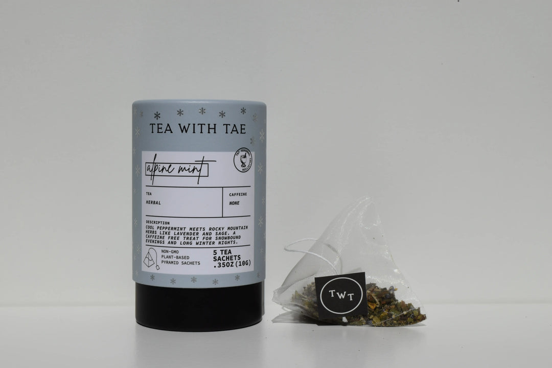 Light blue Alpine Mint mini tea tube beside a pyramid tea sachet and loose tea