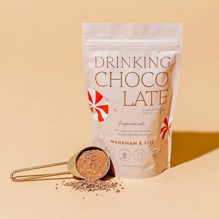Markham &amp; Fitz Peppermint Drinking Chocolate pouch with a scoop of chocolate shavings in front