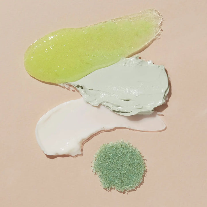 Swatches of the Green Tea Detox scrub, masque and butter with a mound of green sea salt soak