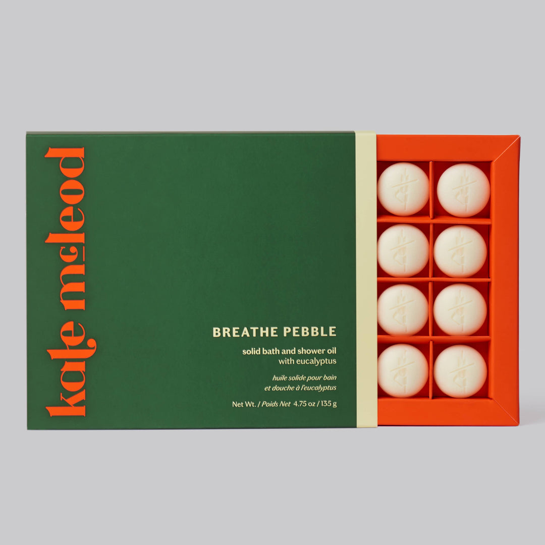 Kate McLeod Breathe Pebble solid bath and shower oil, white pebble on a green tray