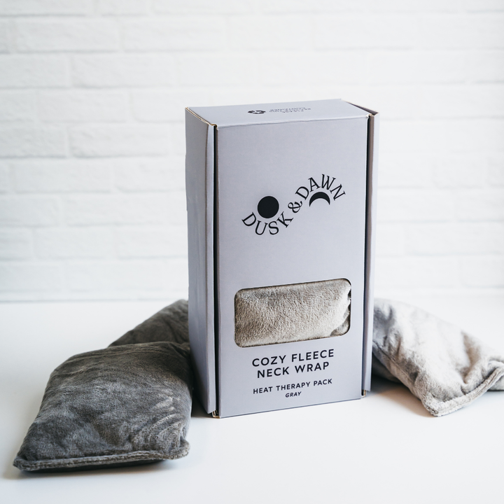 Cozy Fleece Neck Wrap gift box standing upright with two gray fleece wraps