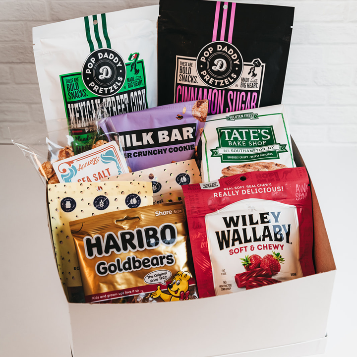 Assorted snack packages including Haribo Goldbears, Tate's Bake Shop, and Wiley Wallaby in a box.