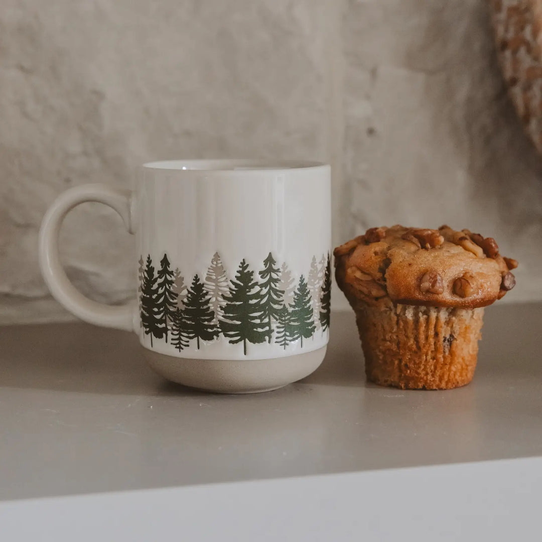 The cream stoneware mug on a counter beside a walnut muffin, showing its size next to a single serving