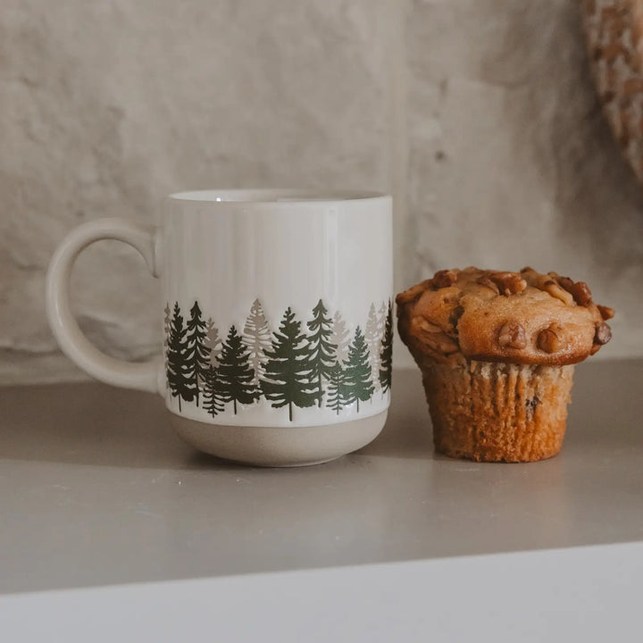 The cream stoneware mug on a counter beside a walnut muffin, showing its size next to a single serving