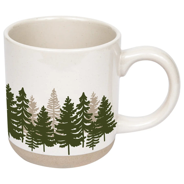 The mug alone on white, angled to show the handle, the cream speckled interior, and the tree design