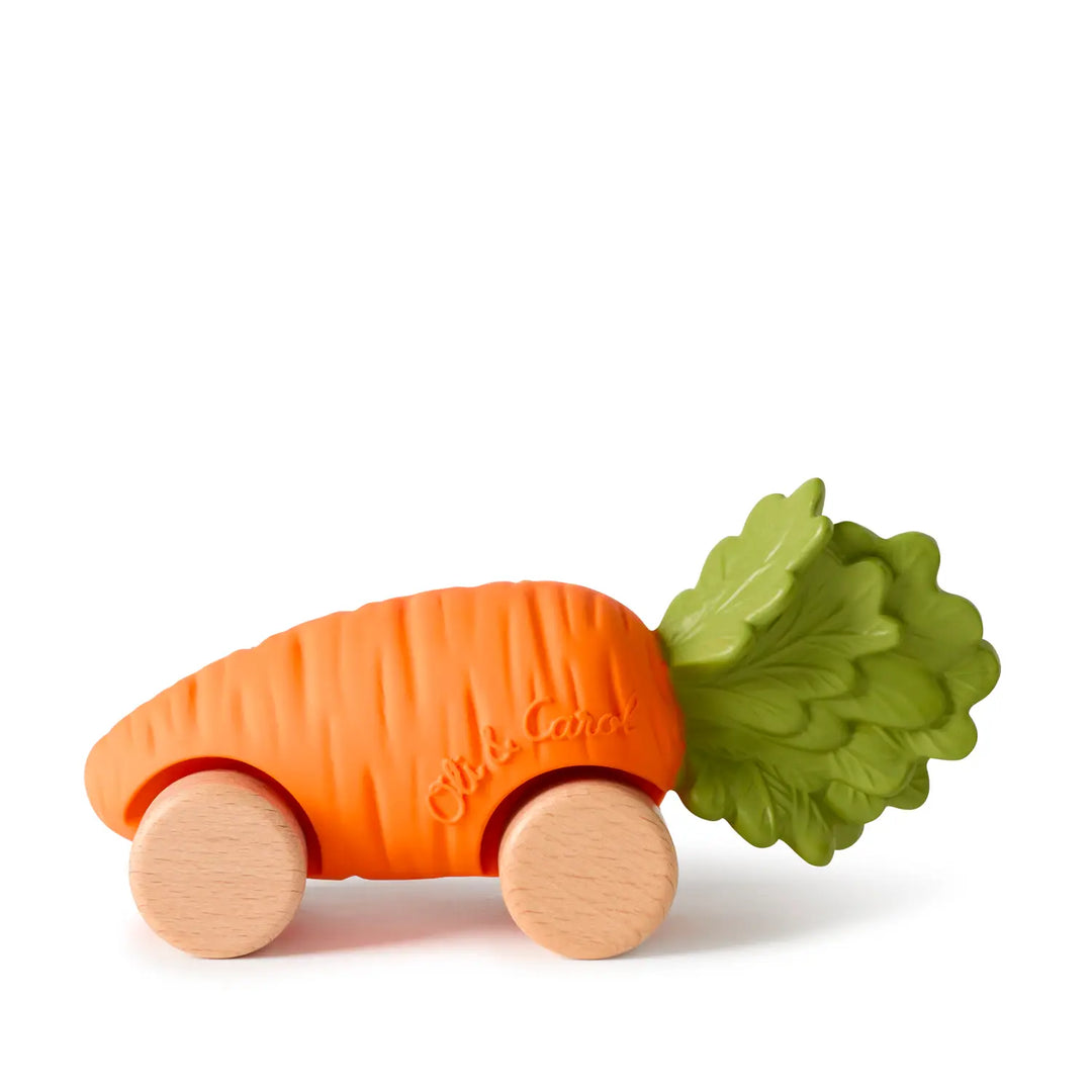 Orange natural rubber carrot car with a green leafy top and four natural wood wheels, shown from the side on a white background.