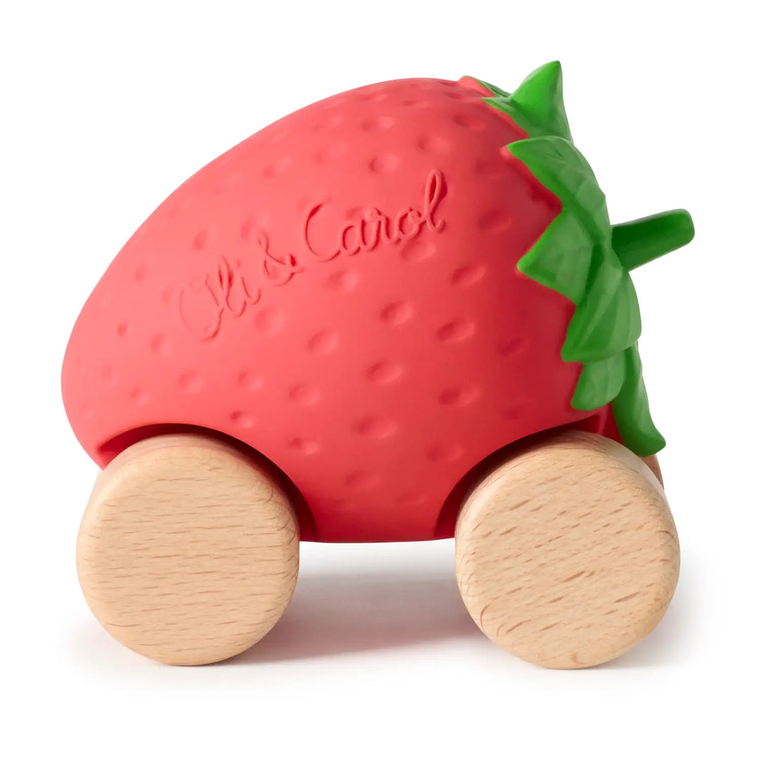 Red natural rubber strawberry car with a green leafy top and four natural wood wheels, shown from the front on a white background.