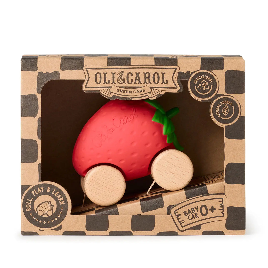 Front view of the kraft Oli &amp; Carol box with a black checkered print, the red strawberry car visible through the window.