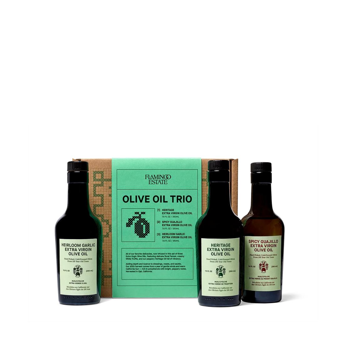 Three Flamingo Estate olive oil bottles side by side: Heritage, garlic infused, and chile infused extra virgin olive oil