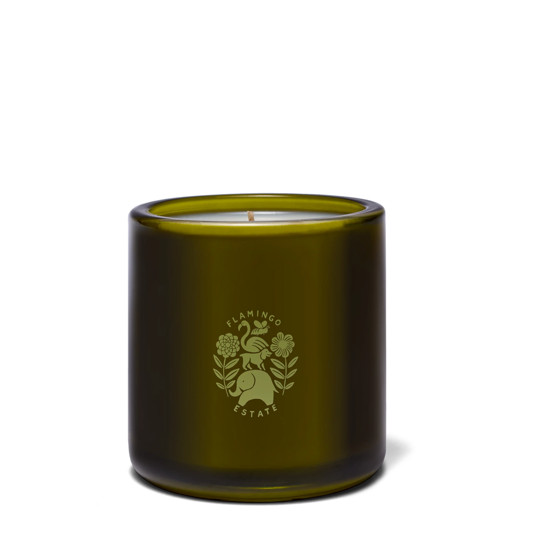 Back of the olive glass Green Goddess candle showing the debossed Flamingo Estate crest, cream soy wax and a single cotton wick