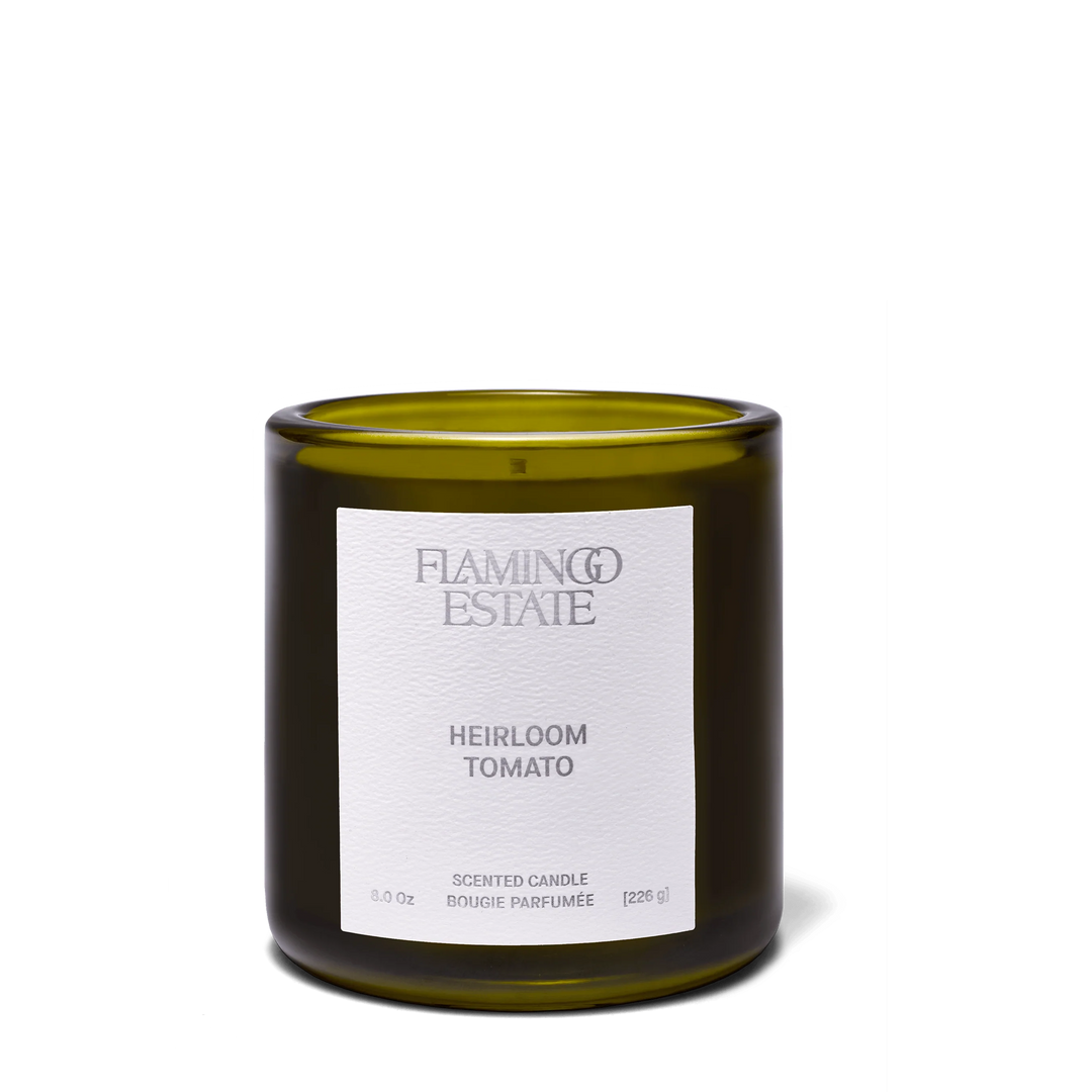Flamingo Estate Heirloom Tomato Candle in an olive-green glass vessel with a white paper label, front view on a white background