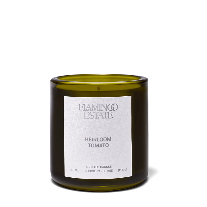 Flamingo Estate Heirloom Tomato Candle in an olive-green glass vessel with a white paper label, front view on a white background