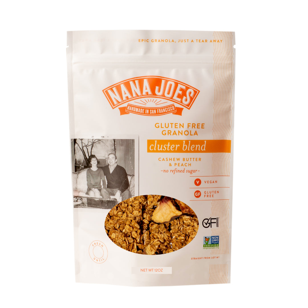 Front of the Nana Joes cluster blend granola bag, labeled cashew butter and peach, with a window showing the clusters