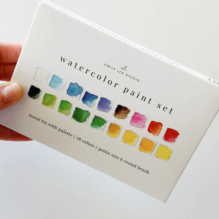 Hand holding the white watercolor paint set box, showing its size