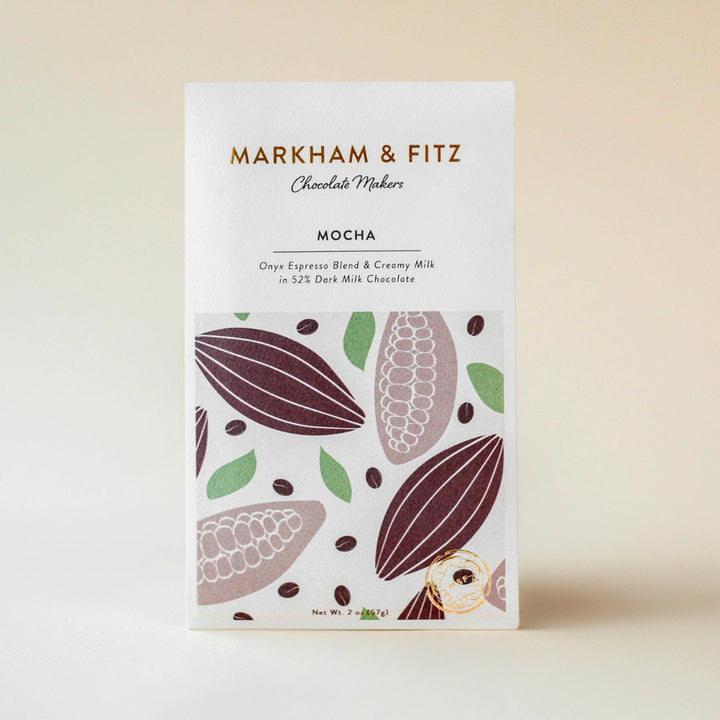 Front of the Markham &amp; Fitz Mocha sleeve, cream paper printed with gold type, mauve cacao pods and coffee beans