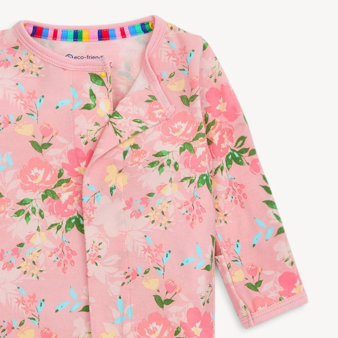 Pink floral baby footie sleeper with long sleeves and colorful inner collar